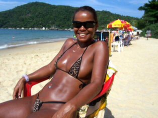 Afro lady on a beach. she's a wonderful and highly scorching