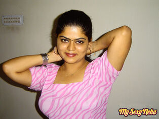 Indian chick Neha sets her inborn tits free of a dark-hued..